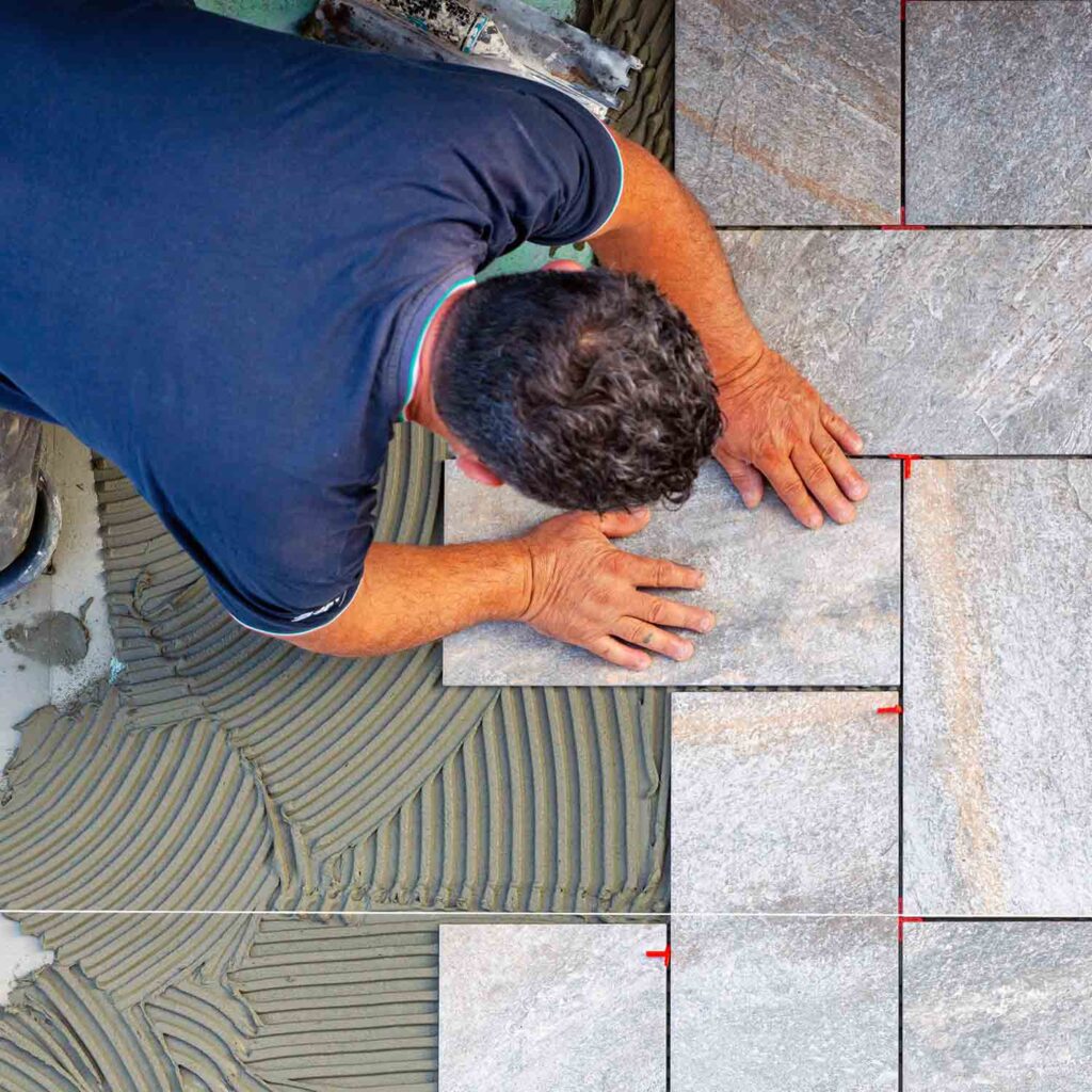 Construction worker laying tile