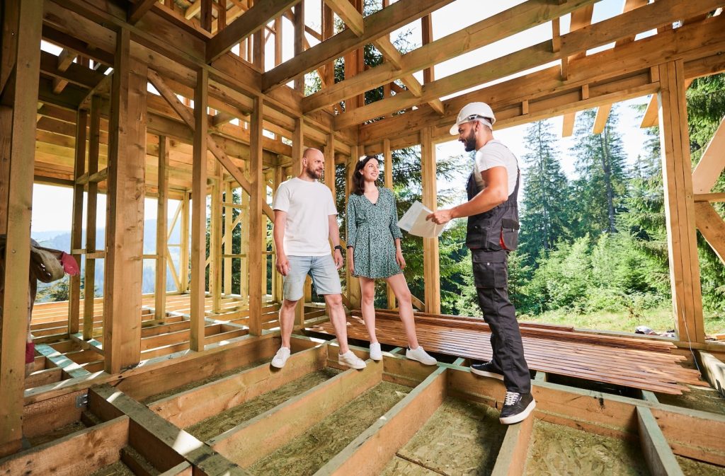 A couple discussing custom home plans with a builder