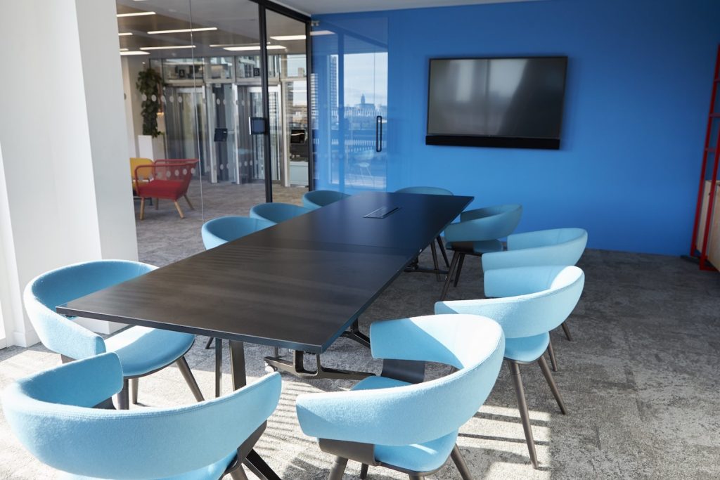 Blue chairs and an accent wall incorporate color