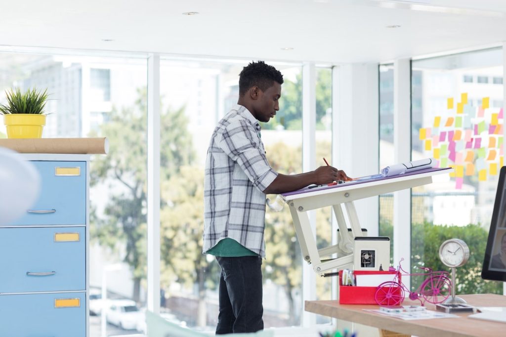 A man working at a standing desk